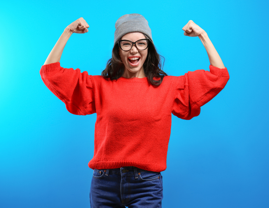 Young Woman Showing Strength Gesture 