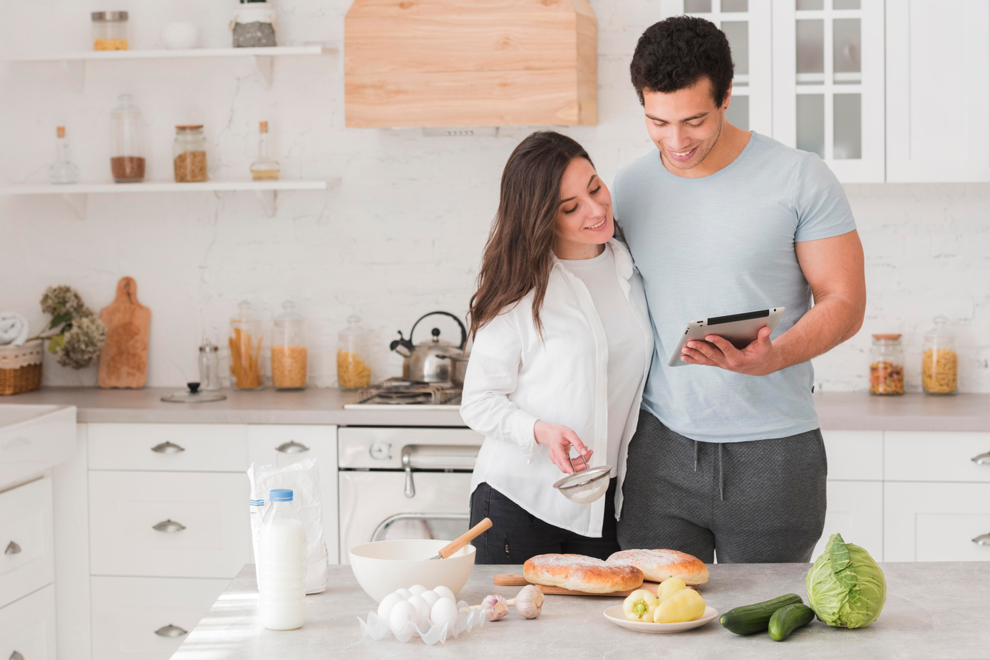 happy couple learning how cook from online recipes